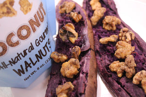 Coconut coated walnut snacks being used as a topping for purple baked potatoes