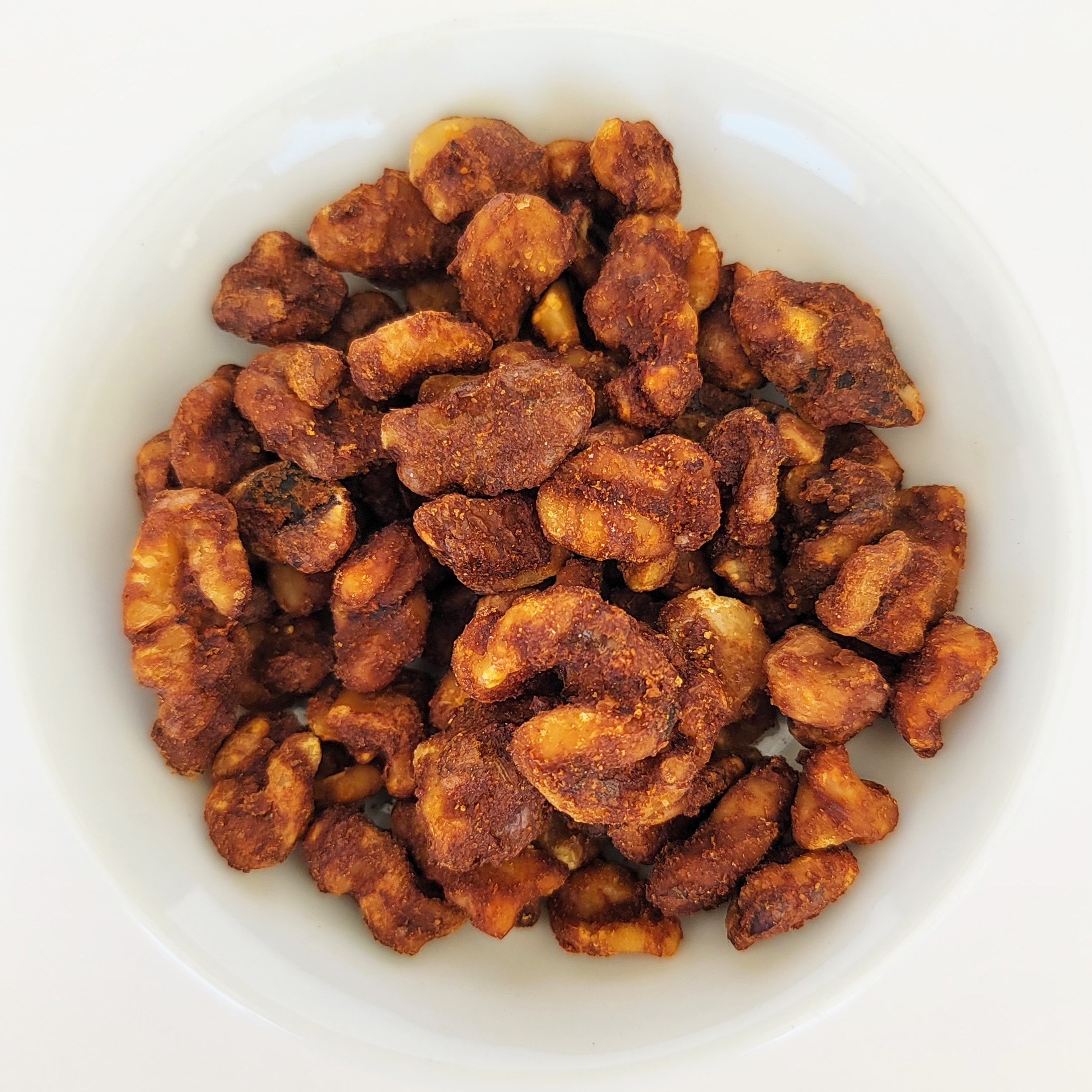 A bowl of Hawaiian BBQ coated walnut snacks