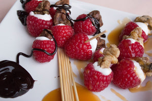 Raspberries stuffed with chocolate and maple coated walnut snacks