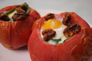 Buffalo seasoned walnut snacks being used as a topping for stuffed tomatoes
