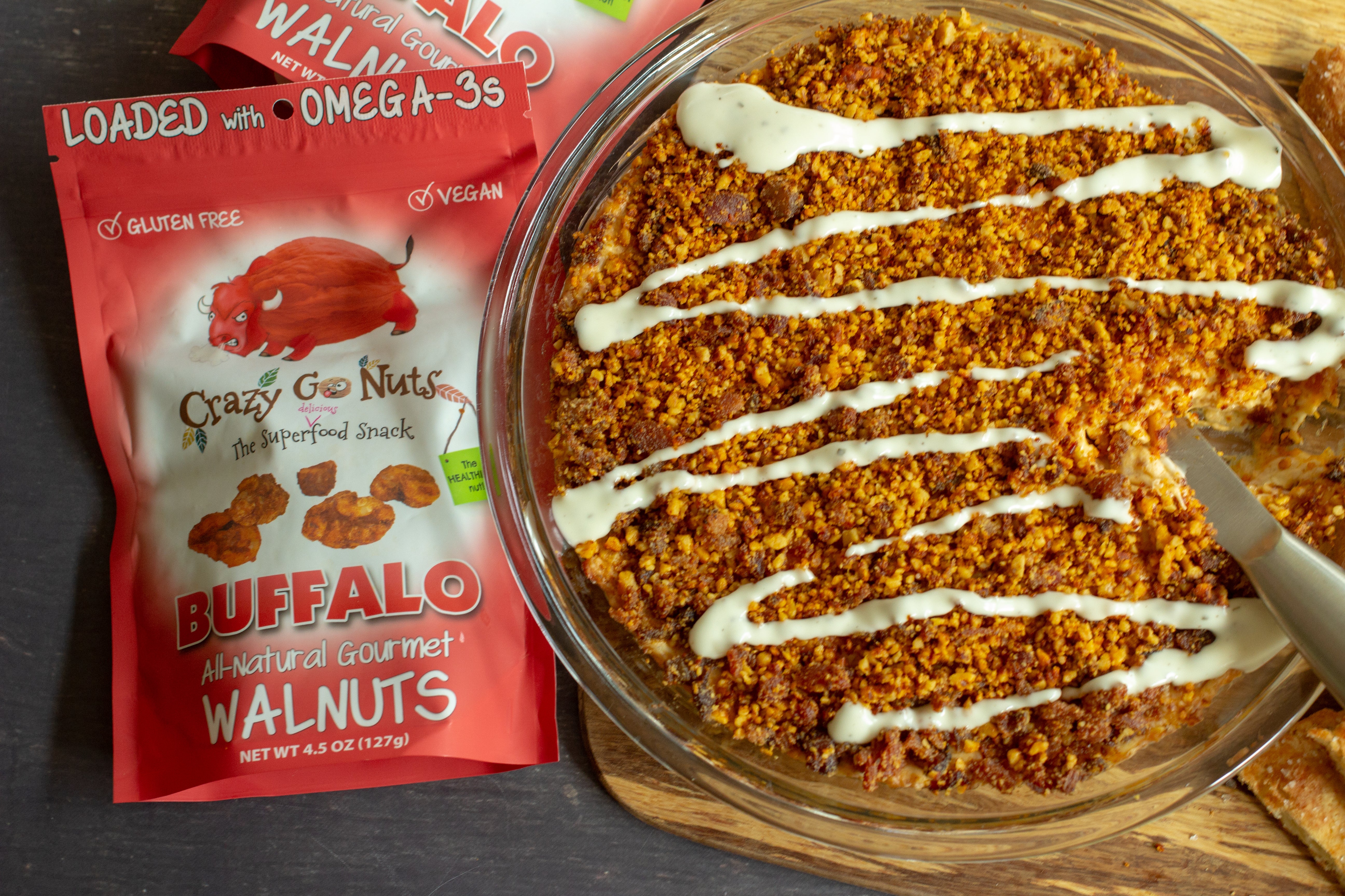 Buffalo walnuts crushed and sprinkled on top of a layer dip