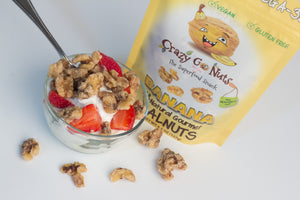 Banana coated walnut snacks being used as a yogurt topping with strawberries