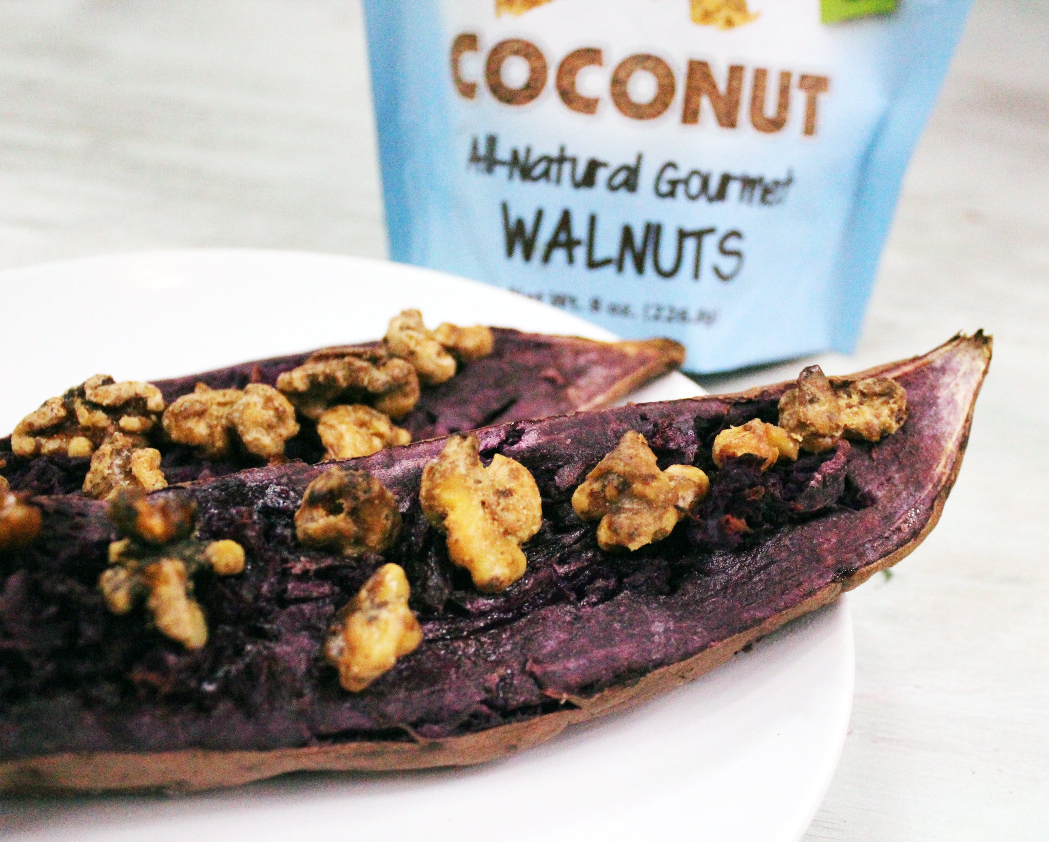 Purple baked potatoes topped with coconut coated walnut snacks