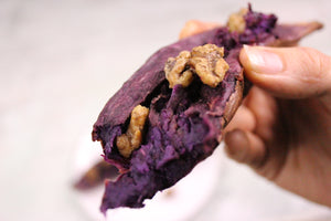 Close up of purple potato with coconut walnuts on top