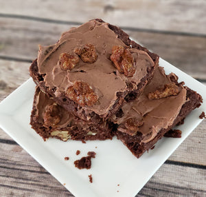 A stack of brownies topped with chocolate espresso walnuts